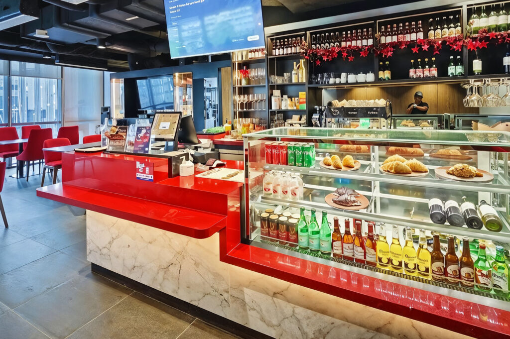 Modern café counter with pastries and drinks on display.