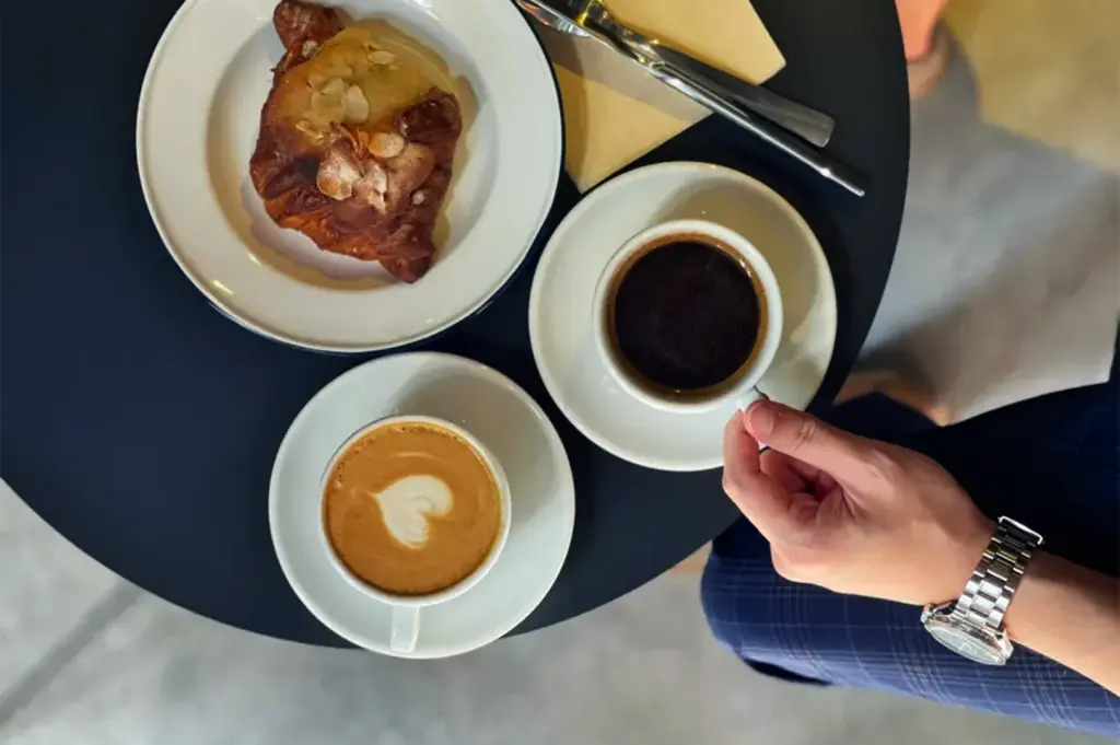 Coffee and pastry on a table at Alchemist The Mill café in Singapore.