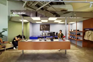 Alchemist Funan Singapore interior with open concept layout, glass reflections, pastel walls, and modern coffee bar inside Funan mall