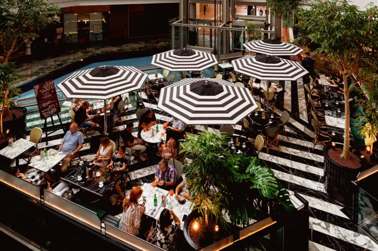 PS Cafe Marina Bay Sands Singapore crowded during lunch with busy outdoor seating and harsh midday lighting showing contrast to morning cafe scene