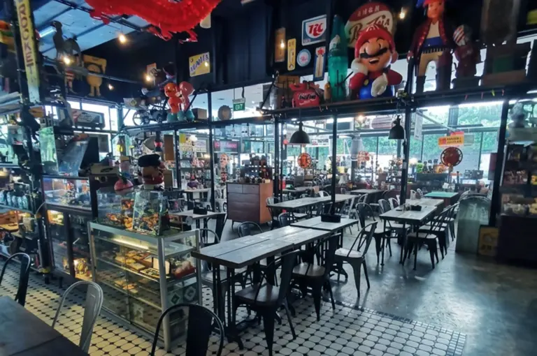 Cafe interior with red dragon decoration, display cases, and checkered floor