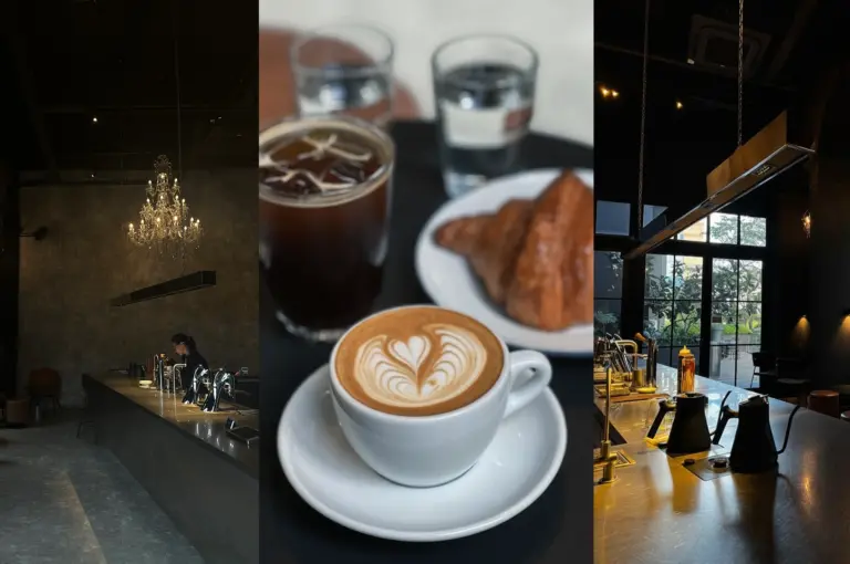 Modern dark cafe interior with high ceilings, crystal chandeliers, and natural light from large windows
