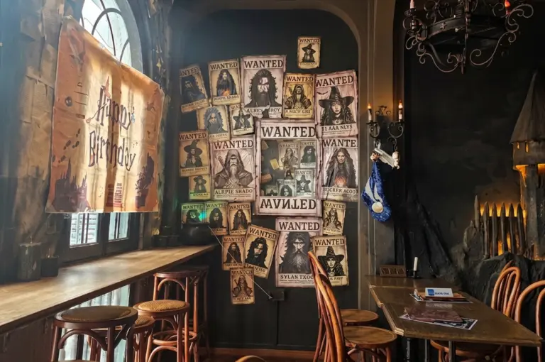 The Wizard's Brew, Singapore. A fantasy-themed cafe interior with a wall of posters.