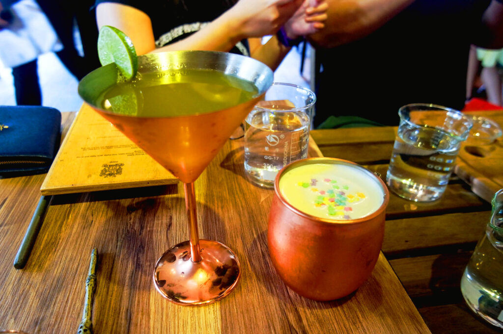 Fantasy themed drinks at Platform 1094 Singapore served in magical style glassware on wooden table inside Harry Potter inspired cafe