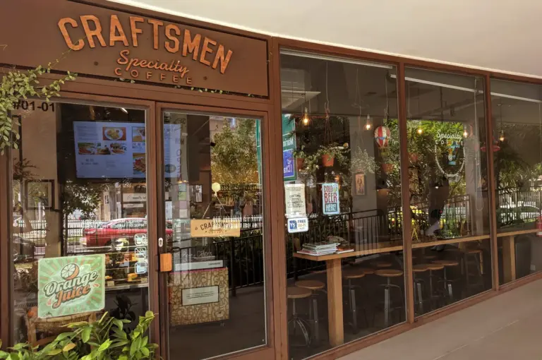 Craftsmen Specialty Coffee cafe entrance with glass doors and signage.