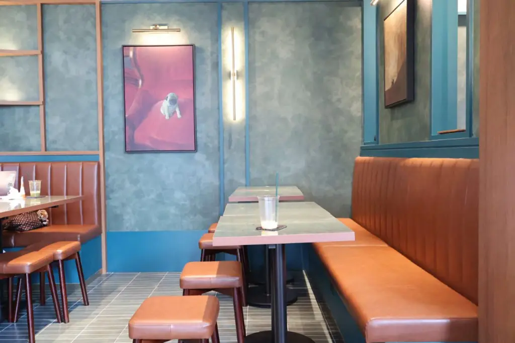 Cafe Yasuragi interior with booth seating and blue wall.